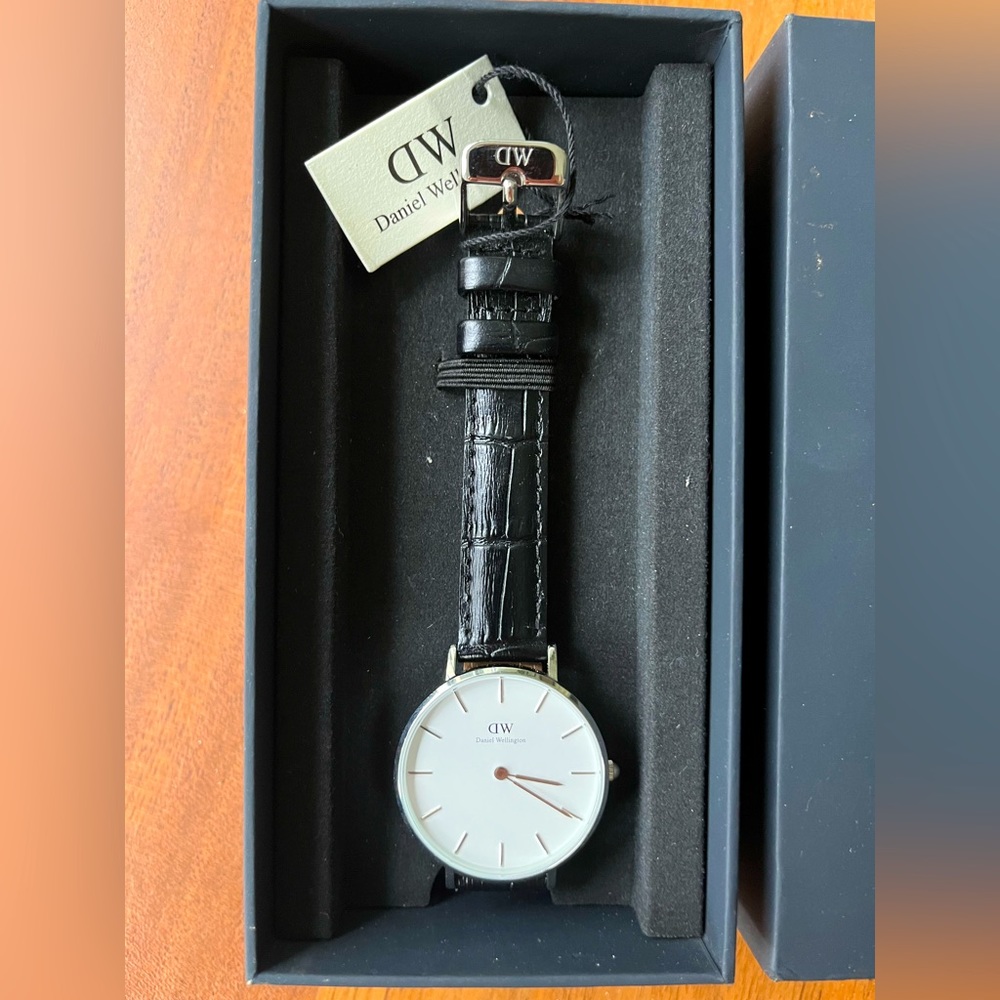 Black leather, Daniel Wellington watch with sterling silver details.